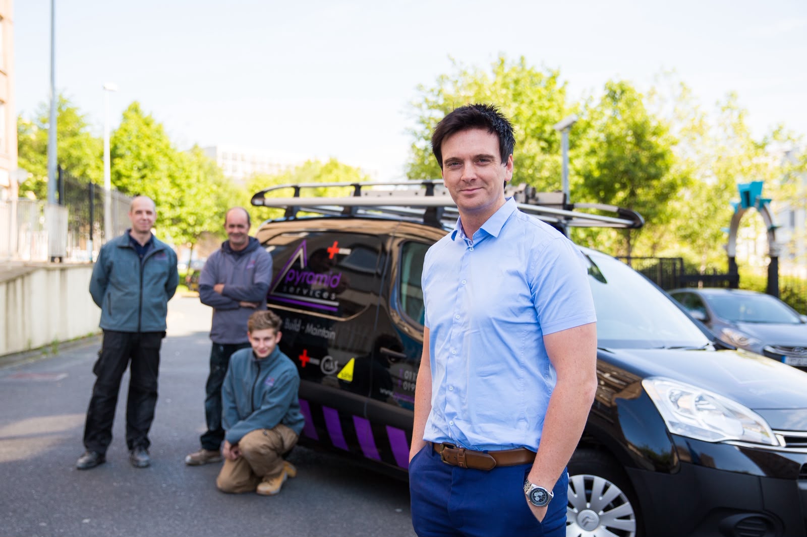 Harry McKeown, director of Pyramid Services, with the engineering team in front of a liveried Pyramid Services van