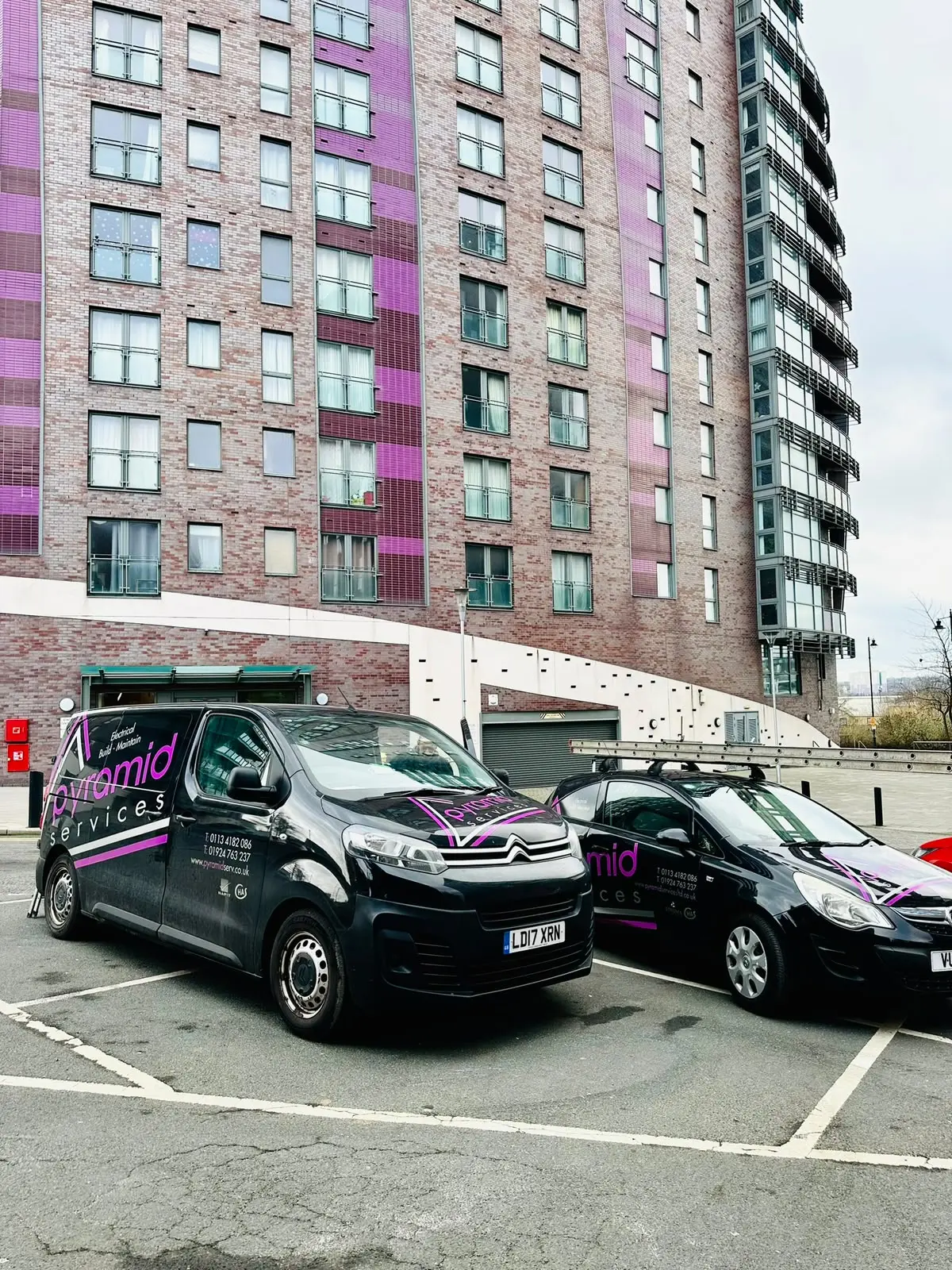 Pyramid Services vans parked outside a Leeds apartment block
